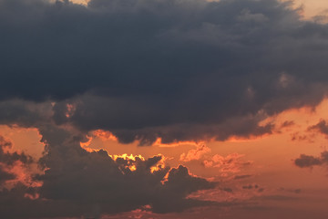 Sunset with dark grey and black clouds, room for copy