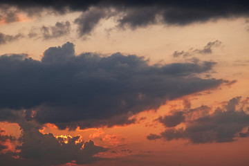 Sunset with grey and black clouds, room for copy