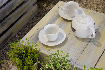 teapot and cups on wooden table