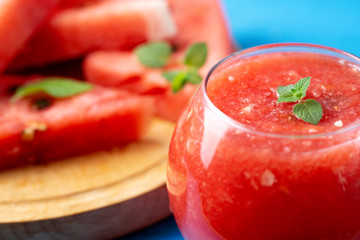 Fresh watermelon smoothie on wooden blue background .