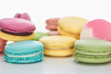 Fototapeta na wymiar close up view of sweet colorful French macaroons of different flavors on white background