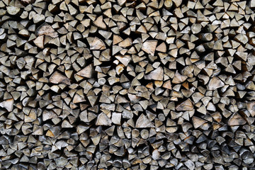 A pile of stacked firewood, prepared for heating the house. Firewood harvested for heating in winter