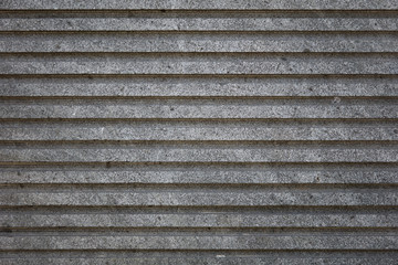 Rough grey concrete cement striped wall