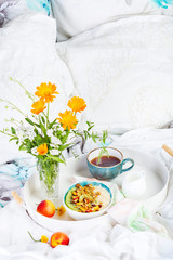 Bowl of fresh oatmeal porridge with kiwi, peach and granola