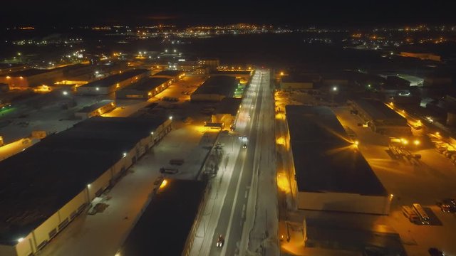 In the night city there are several warehouses and dumps for spare parts of old aircraft. Shooting from quadrocopter. The landscape is breathtaking. Lights of night city beautifully complement picture