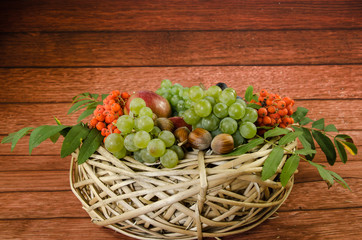 group of healthy autumnal colorful fruits  in wooden basket