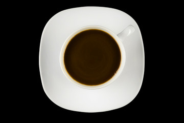 Cup of coffee on a black background - top view
