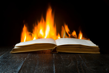 Open book on a background of flames