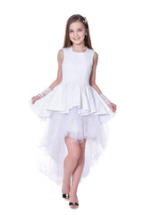 Happy beautiful little girl in white dress posing on white background