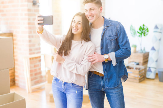 Beautiful young couple smiling happy taking a selfie photo with smartphone, very excited moving to a new home