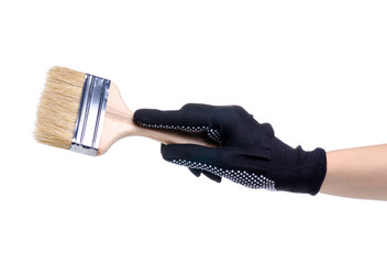 Hands in working gloves holding building paint brush on white background isolation