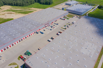 Aerial view of goods warehouse. Logistics center in industrial city zone from drone view. Background texture concept.