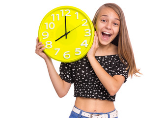 Smiling Teen Girl holding Big Clock, isolated on white background. Portrait of caucasian funny...