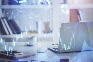 Stock market graph on background with desk and personal computer. Multi exposure. Concept of financial analysis.