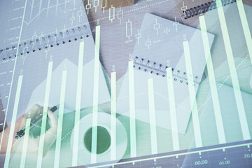 Multi exposure of woman's hands making notes with forex graph hologram. Concept of technical analysis.