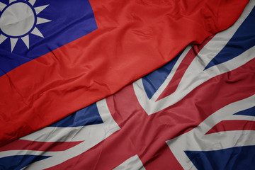 waving colorful flag of great britain and national flag of taiwan.
