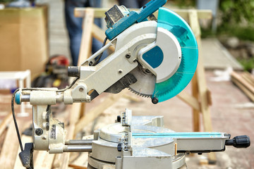 Close-up of a laser circular saw at a construction site. Products for home and garden and production. Building tool.