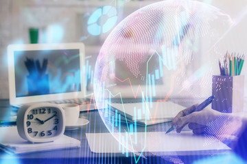 Financial graph displayed on woman's hand taking notes background. Concept of research. Multi exposure