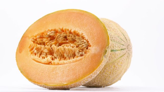 Sweet cantaloupe rotating, (loopable) on white background. Filmed in 4K