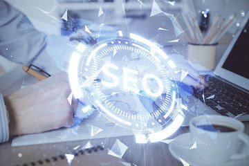 Double exposure of seo icon with man working on computer on background. Concept of search engine...