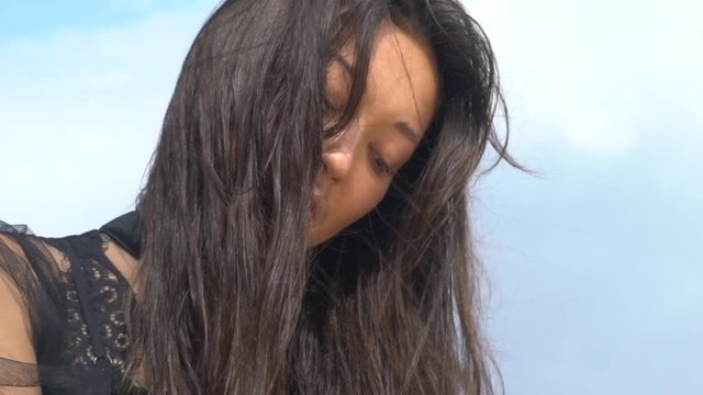 Face of a girl of Asian appearance with black hair close-up.