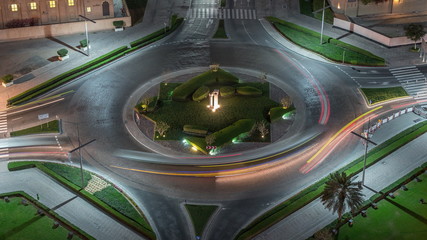 Aerial view of a roundabout circle road in Dubai downtown from above night timelapse. Dubai, United...