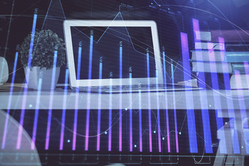 Stock market chart hologram drawn on personal computer background. Double exposure. Concept of investment.