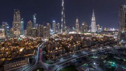 Fototapeta na wymiar Dubai Downtown skyline night timelapse with Burj Khalifa and other towers paniramic view from the top in Dubai
