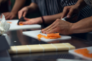 Obraz na płótnie Canvas fresh sushi preparation, smoked salmon