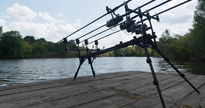 Timelapse, carp fishing, rodpod, fishing rods, reels on a wooden platform