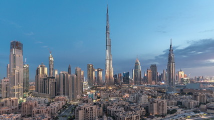 Dubai Downtown skyline night to day timelapse with Burj Khalifa and other towers paniramic view from the top in Dubai