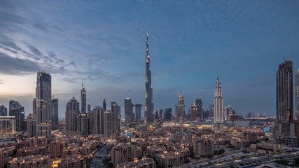 Fototapeta na wymiar Dubai Downtown skyline day to night timelapse with Burj Khalifa and other towers paniramic view from the top in Dubai