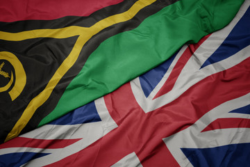 waving colorful flag of great britain and national flag of Vanuatu.