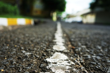 The paved road has White traffic lines on the surface. Blurred background Places in Thailand