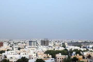 Fototapeta na wymiar The predominantly low-rise homes, offices and other buildings in the Al Badi area of the Omani capital, Muscat on 8 August 2017