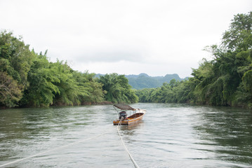 Fishing boat on the river go to the rain forest.