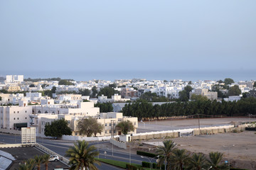 The white-washed low-rise homes, offices and other buildings of the Al Ghubra area of the Omani capital, Muscat on 8 August 2017
