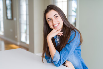 Beautiful young brunette woman smiling cheerful looking at the camera with a big smile on face showing teeth