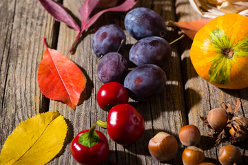 autumn fruits and vegetables on weathered wooden table background