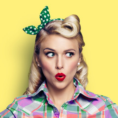  Photo of surprised woman, looking sideways, pinup style, over yellow