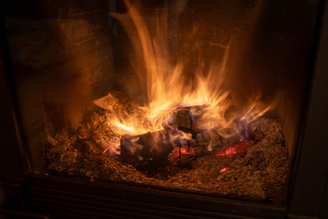 Wood burning at fireplace, captured as long exposure and close up shot for texture in woods.