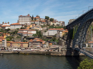 Fototapeta na wymiar Portugal, may 2019: Scenic view of the Porto Old Town pier architecture over Duoro river in Porto