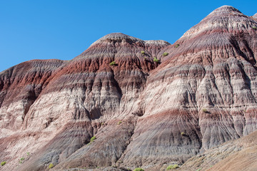 Landscape of purple, red, pink and white striped or banded hills at Paria Canyon in Grand Staircase Escalante National Monument