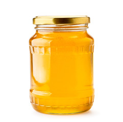Honey in a glass jar close-up on a white. Isolated.