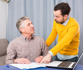 Adult father and son discuss contract