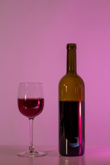 A bottle of wine and a glass