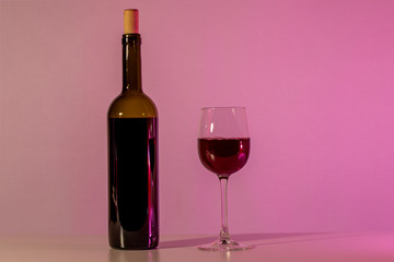 A bottle of wine and a glass