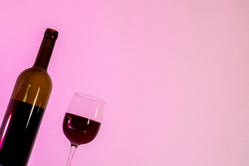 A bottle of wine and a glass