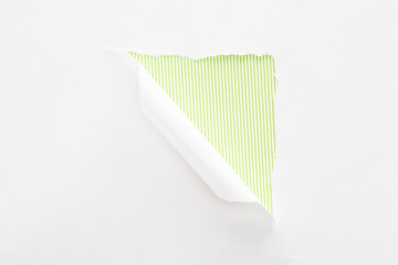 Naklejka premium white torn and rolled paper on colorful lime green striped background