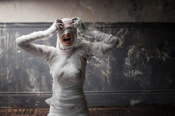 mummy screams in horror and tears the bandages. The girl with the bandage.